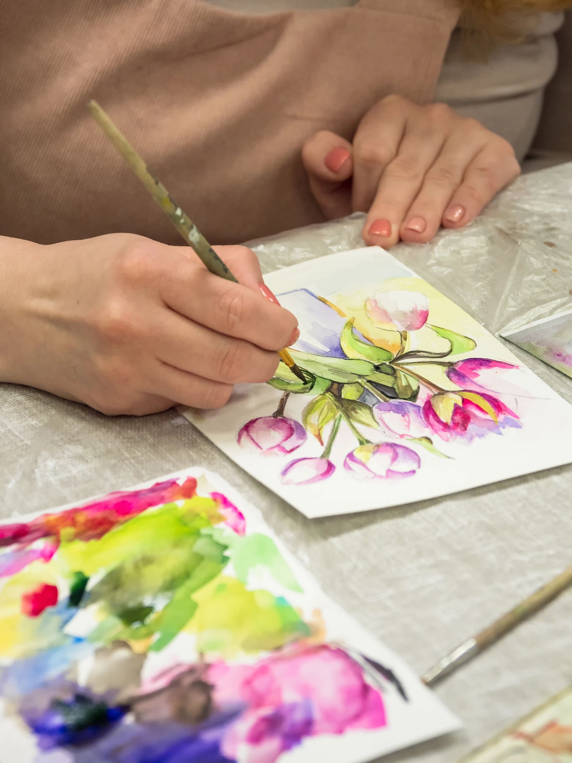 Artist painting colorful flowers with watercolor